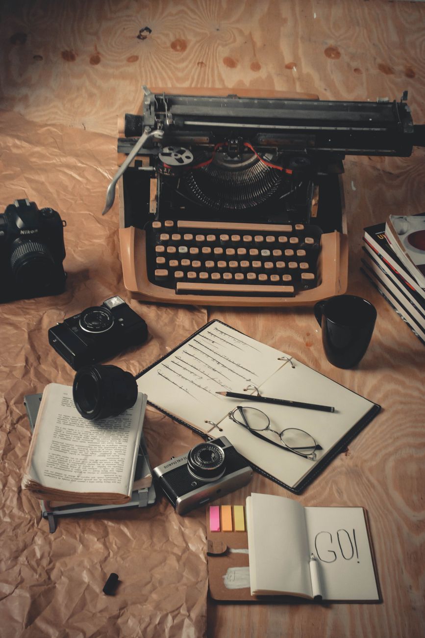 Travel writer reviewing notes on a rustic wooden desk