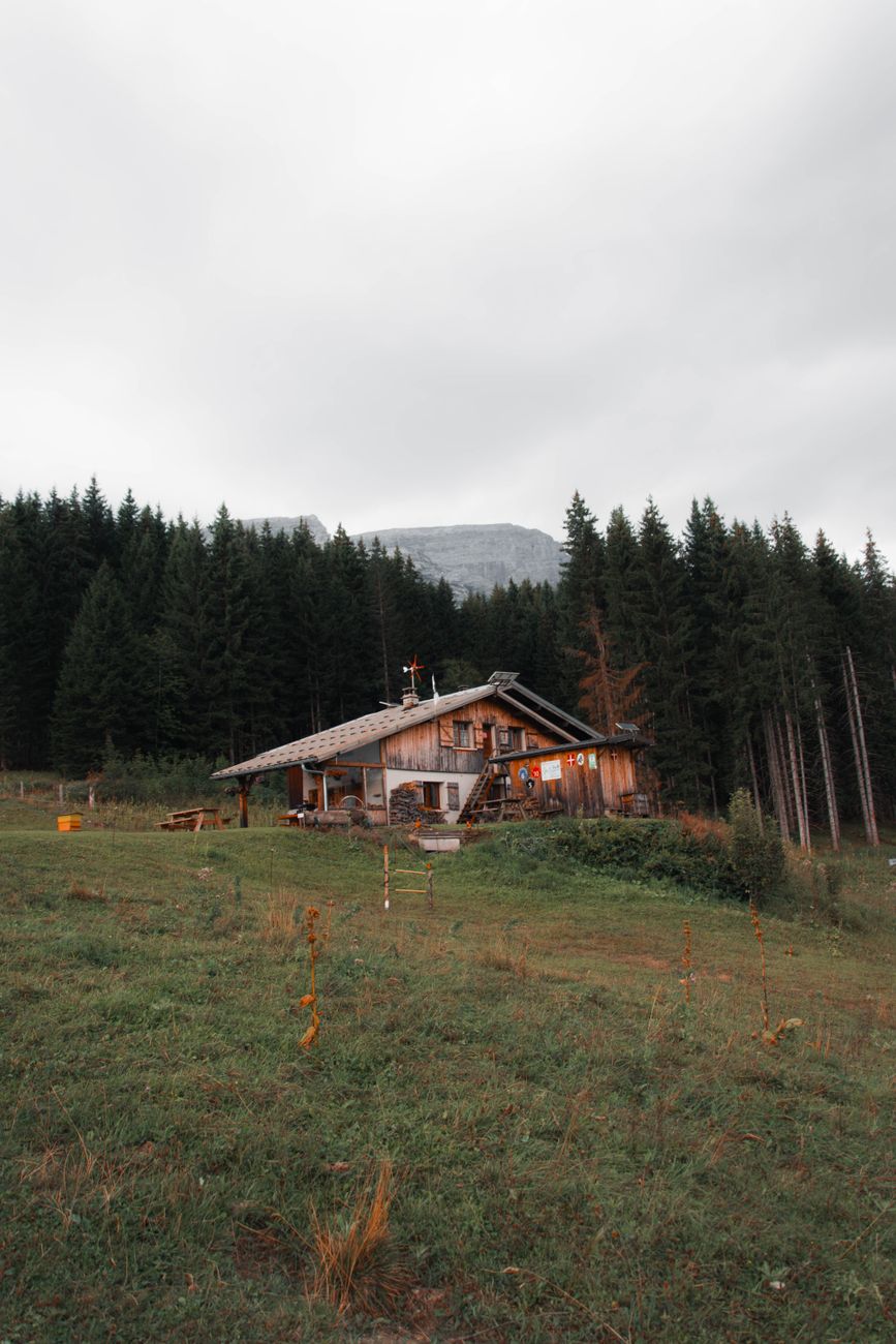 Alpine timber refuge under towering limestone peaks